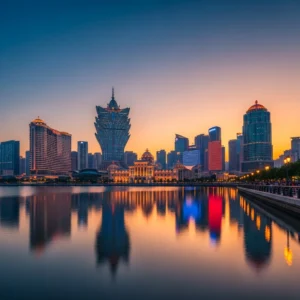 Panoramica di resort di lusso a Macao illuminati al tramonto, con riflessi sull'acqua e figure umane distanti.
